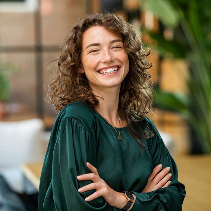Beautiful woman smiling with crossed arms