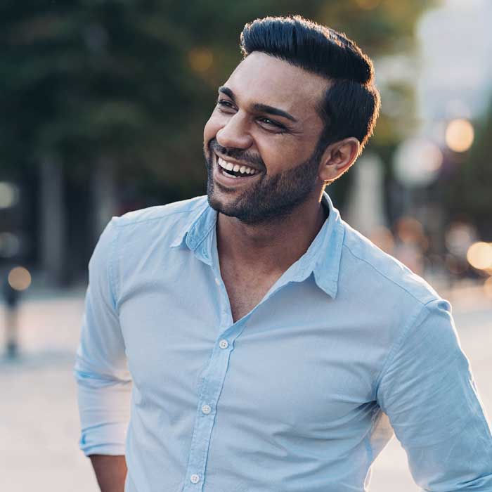 Smiling young man walking outdoors