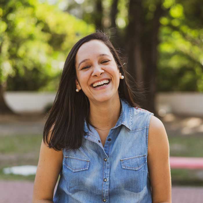 Portrait, young woman smiling, public park, outdoors