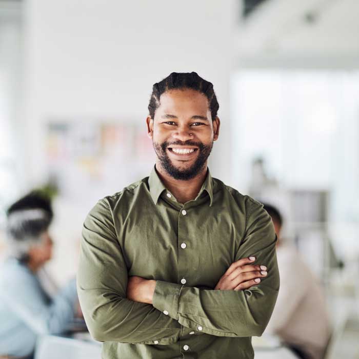 Smiling businessman with arms crossed