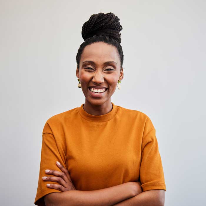 Young businesswoman laughing with her arms crossed