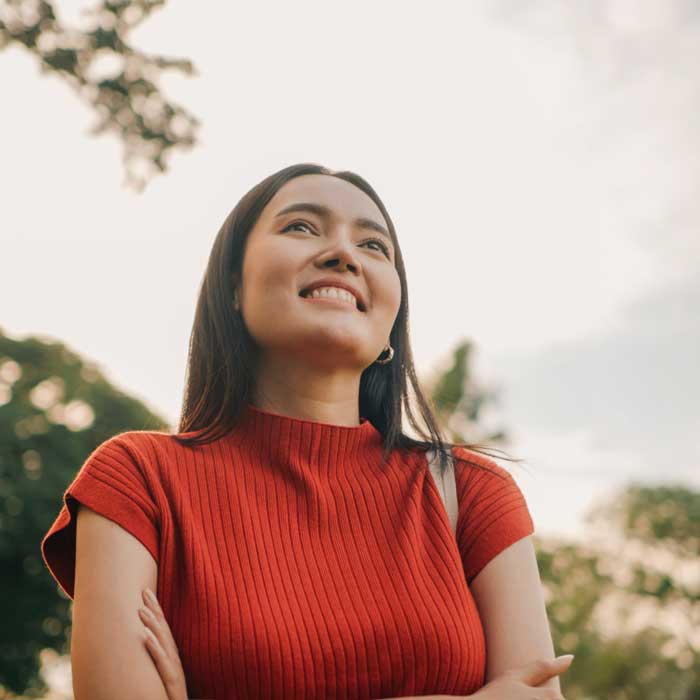 Smiling woman in sunny park setting